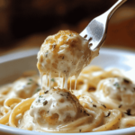 A skillet filled with sizzling garlic butter chicken balls.